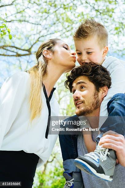 mother kissing goodbye husband and son before going to work - gap france stock pictures, royalty-free photos & images