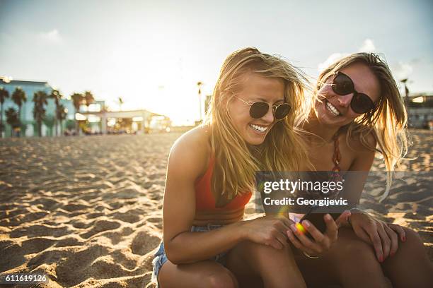 happiness is a day at the beach - cell phone using beach stock pictures, royalty-free photos & images