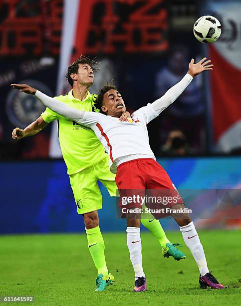 Yussuf Yurary Poulsen of Leipzig is challenged by Paul Verhaegh of Augsburg during the Bundesliga match between RB Leipzig and FC Augsburg at Red...