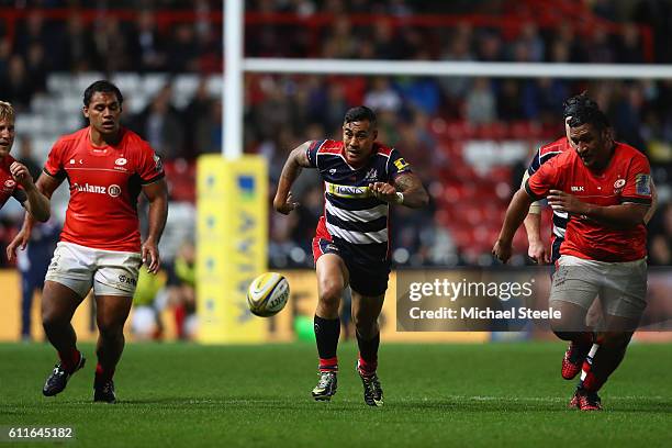 Tusi Pisi of Bristol chases a loose ball alongside Mako Vunipola and Billy Vunipola of Saracens during the Aviva Premiership match between Bristol...