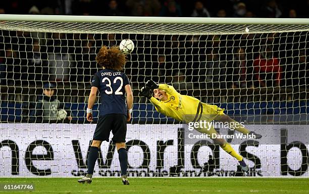 Chelsea goalkeeper Thibaut Courtois makes a save from an attempt on goal by Paris Saint-Germain's David Luiz