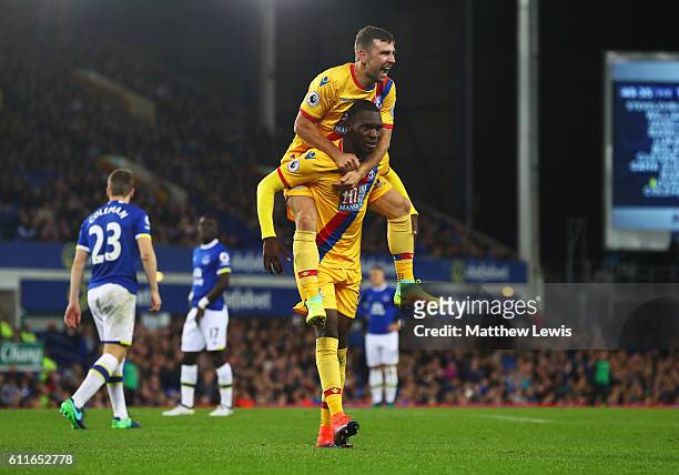 Christian Benteke of Crystal Palace celebrates with James McArthur as he scores their first goal during the Premier League match between Everton and...