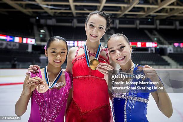 Mako Yamashita of Japan, Polina Tsurskaya and Elizaveta Nugumanova of Russia and pose for a photo during the Junior Ladies Medal Ceremony on day two...