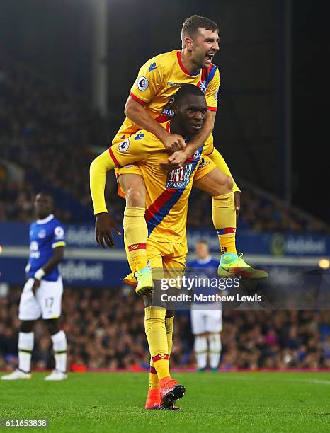 Christian Benteke of Crystal Palace celebrates with James McArthur as he scores their first goal during the Premier League match between Everton and...