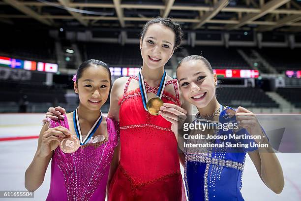 Mako Yamashita of Japan, Polina Tsurskaya and Elizaveta Nugumanova of Russia and pose for a photo during the Junior Ladies Medal Ceremony on day two...
