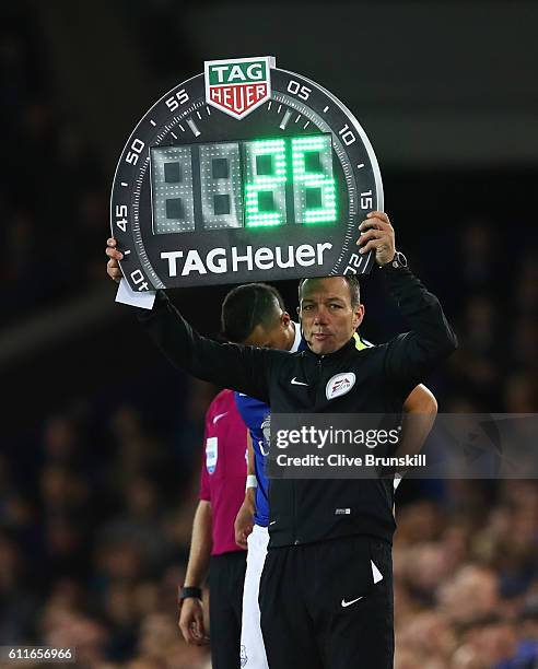 Fourth official Kevin Friend holds an electronic board as he oversees a substitution during the Premier League match between Everton and Crystal...