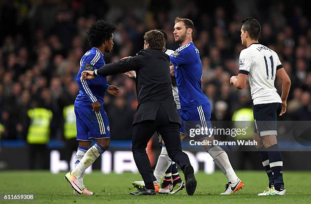 Tottenham Hotspur manager Mauricio Pochettino steps onto the pitch to separate Tottenham Hotspur's Danny Rose and Chelsea's Willian