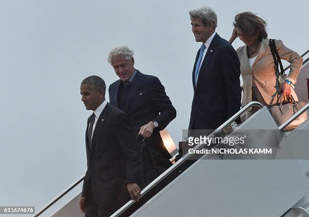 President Barack Obama , former president Bill Clinton , Secretary of State John Kerry and House Minority Leader Nancy Pelosi walk off Air Force One...