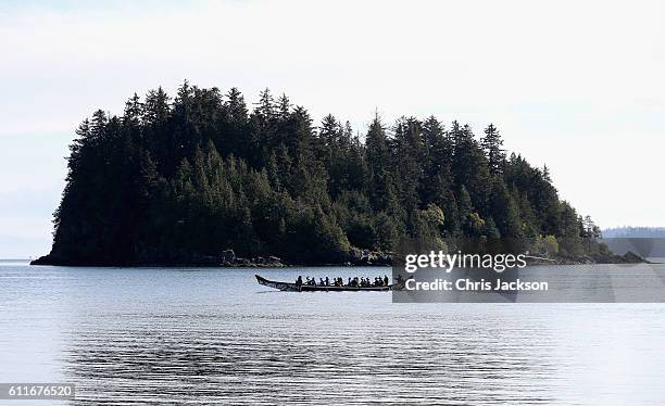 Catherine, Duchess of Cambridge and Prince William Duke of Cambridge arrive in a traditional canoe at Haida Heritage Centre on September 30, 2016 in...