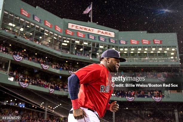 David Ortiz of the Boston Red Sox runs onto the field as he is introduced during a retirement tribute ceremony before a game against the Toronto Blue...