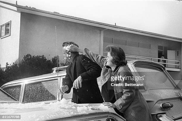 Golfer Arnold Palmer, Latrobe, Pennsylvania, gets a face full of snow handed him by his wife, Winnie. Final round of Crosby National Pro-Amateur was...