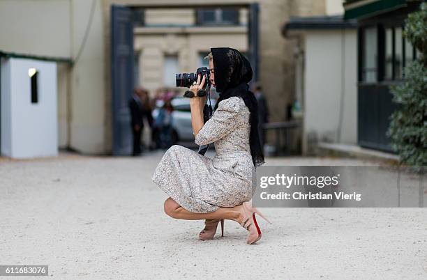 Designer Ulyana Sergeenko taking photos with her Canon Mark III camera outside Dior on September 30, 2016 in Paris, France.