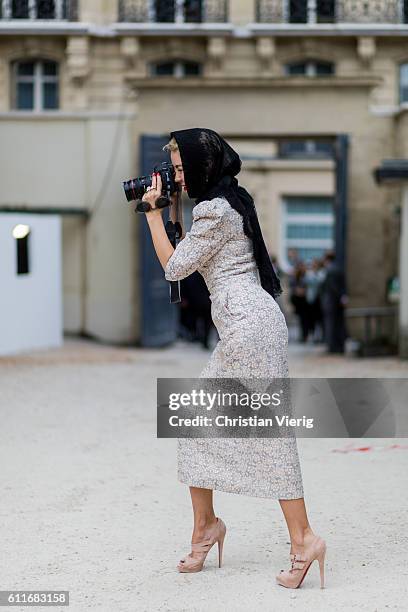 Designer Ulyana Sergeenko taking photos with her Canon Mark III camera outside Dior on September 30, 2016 in Paris, France.