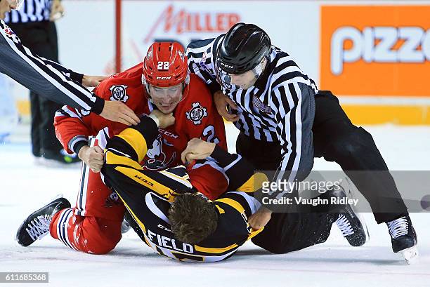 Ryan Mantha of the Niagara IceDogs and Sam Field of the Kingston Frontenacs fight during the second period of an OHL game at the Meridian Centre on...