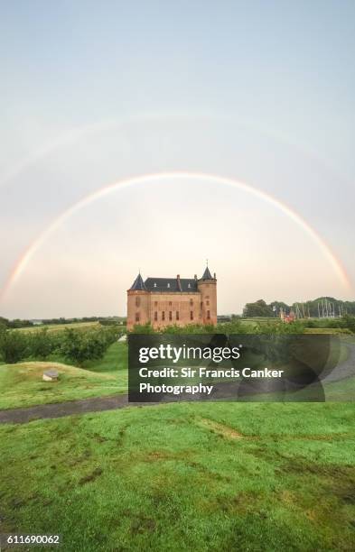 majestic muiderslot castle under a perfect double rainbow in muiden, amsterdam, netherlands - amsterdam gracht stockfoto's en -beelden