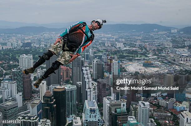 Base jumper leaps from the 300-metre high open deck at Malaysia's Kuala Lumpur Tower during the International Tower Jump on October 1, 2016 in Kuala...