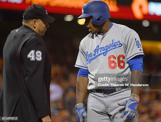 Yasiel Puig of the Los Angeles Dodgers argues with home plate umpire Andy Fletcher after he was called out on strike against the San Francisco Giants...