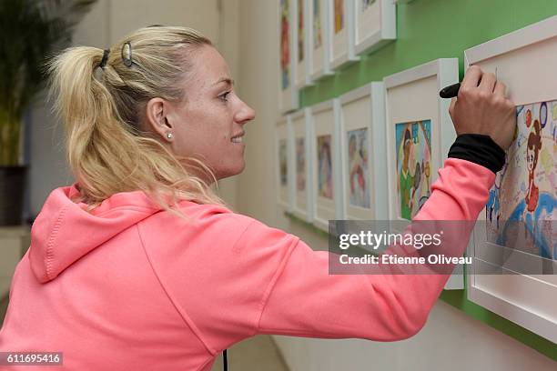 Angelique Kerber of Germany signs an autograph after a press conference on day 1 of the 2016 China Open, at the National Tennis Centre on October 1,...