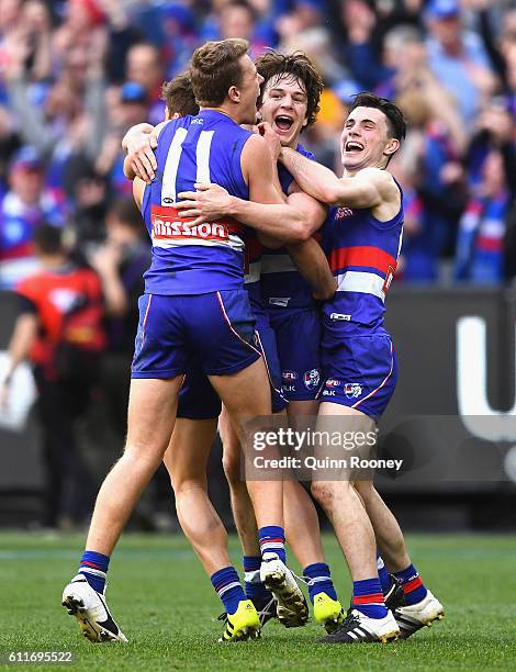 Jackson Macrae, Josh Dunkley, Liam Picken and Toby McLean of the Bulldogs celebrates winning the 2016 AFL Grand Final match between the Sydney Swans...