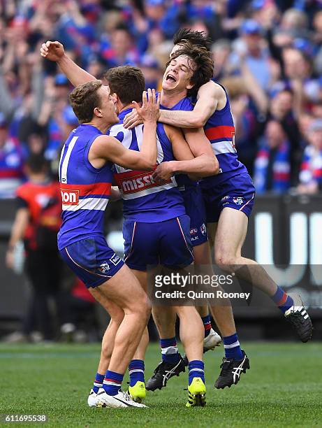 Jackson Macrae, Josh Dunkley, Liam Picken and Toby McLean of the Bulldogs celebrates winning the 2016 AFL Grand Final match between the Sydney Swans...