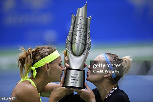 Bethany Mattek Sands of USA and Lucie Safarova of Czech kiss their trophy on day 7 of 2016 Dongfeng Motor Wuhan Open at Optics Valley International...