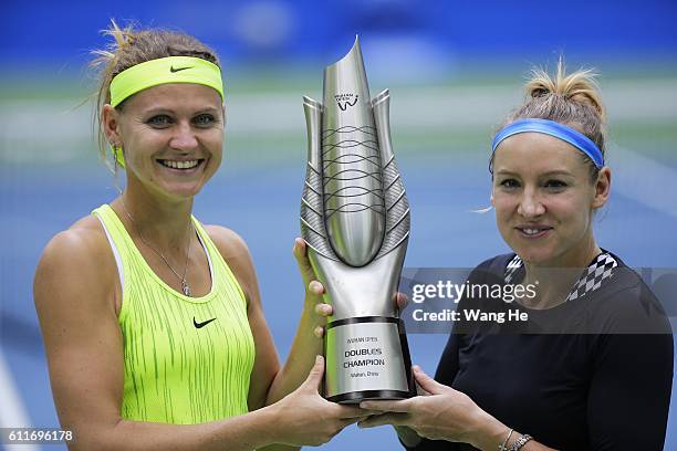 Bethany Mattek Sands of USA and Lucie Safarova of Czech pose for a picture with their trophy on day 7 of 2016 Dongfeng Motor Wuhan Open at Optics...