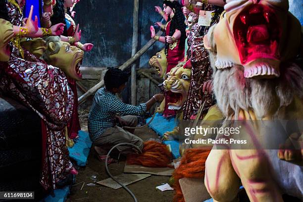An artist spray paints idol of lion for upcoming Durga festival . Today is the most auspicious time is here! Today being the very first day of the...