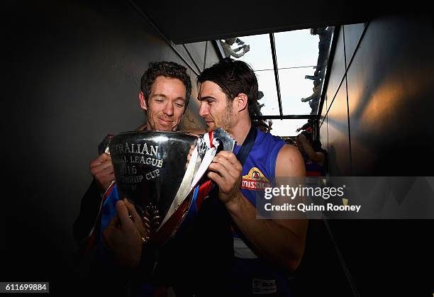 Robert Murphy and Easton Wood of the Bulldogs celebrate with the trophy as they walk down the race after winning the 2016 AFL Grand Final match...