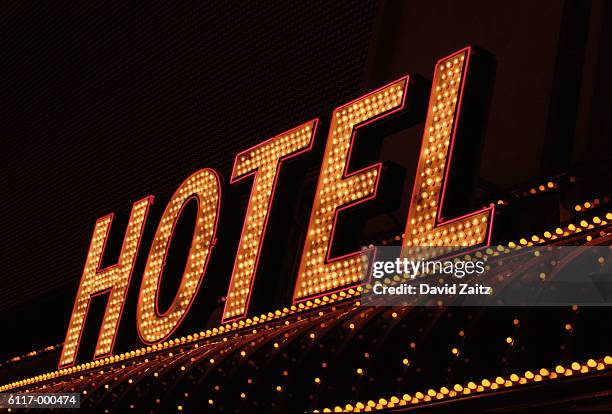 illuminated hotel sign - illuminated sign stock pictures, royalty-free photos & images