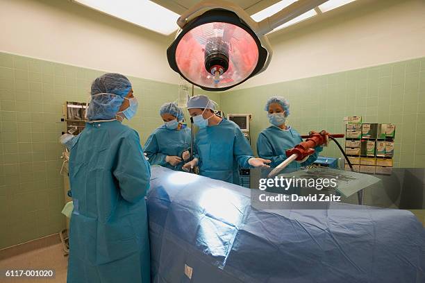 surgeons with pneumatic drill - funny surgical masks stock pictures, royalty-free photos & images