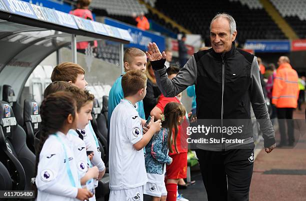 Francesco Guidolin, Manager of Swansea City high fives the Swansea City mascots prior to kick off during the Premier League match between Swansea...