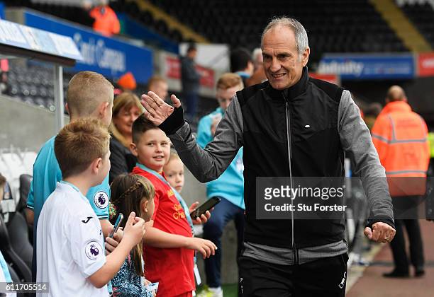 Francesco Guidolin, Manager of Swansea City high fives the Swansea City mascots prior to kick off during the Premier League match between Swansea...