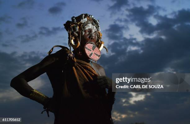 Woman from the Mursi tribe poses for a photo in the Mago National park near Jinka in Ethiopia's southern Omo Valley region on September 21, 2016. The...