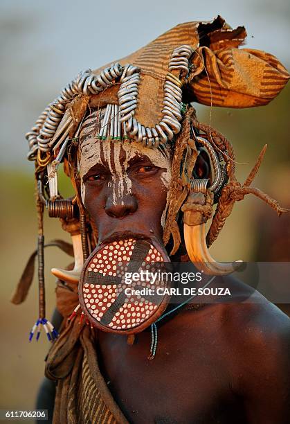 Woman from the Mursi tribe poses for a photo in the Mago National park near Jinka in Ethiopia's southern Omo Valley region on September 21, 2016. The...