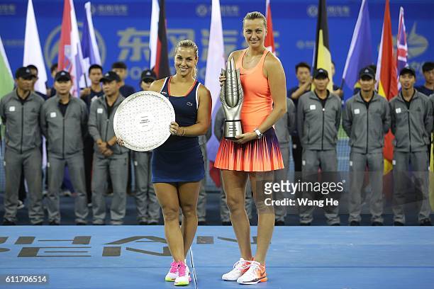 Winners Petra Kvitova of Czech and runners-up Dominika Cibulkova of Slovakia pose for a picture with their trophy on day 7 of 2016 Dongfeng Motor...