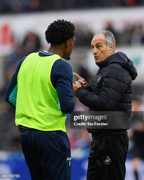 Leroy Fer of Swansea City and Francesco Guidolin, Manager of Swansea City speak before kick off during the Premier League match between Swansea City...