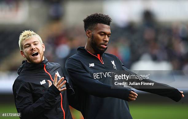 Alberto Moreno of Liverpool and Daniel Sturridge of Liverpool share a joke prior to kick off during the Premier League match between Swansea City and...