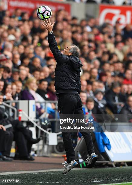 Francesco Guidolin, Manager of Swansea City catches the ball during the Premier League match between Swansea City and Liverpool at Liberty Stadium on...