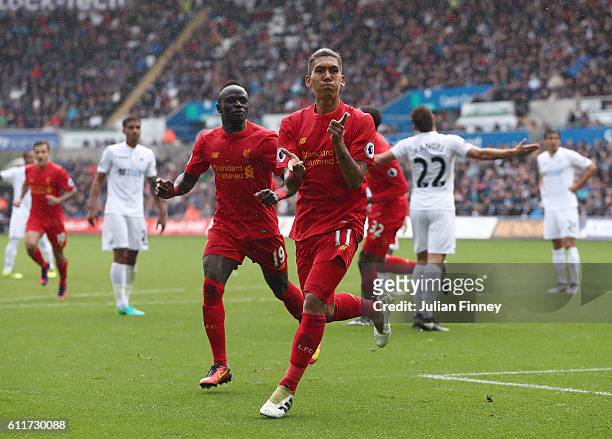Roberto Firmino of Liverpool celebrates scoring his sides first goal during the Premier League match between Swansea City and Liverpool at Liberty...