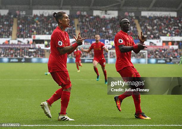 Roberto Firmino of Liverpool and Sadio Mane of Liverpool celebrates their sides first goal during the Premier League match between Swansea City and...