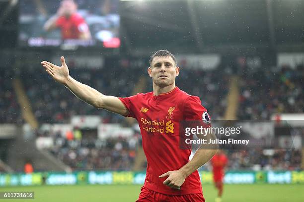 James Milner of Liverpool celebrates scoring his sides second goal during the Premier League match between Swansea City and Liverpool at Liberty...