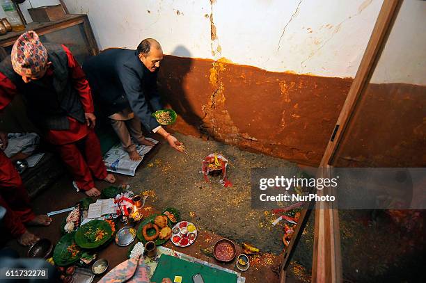 Nepalese Priests spreading barley seeds to grow as 'Jamara', a religious holy flower as the offering of Goddess Durga during the Gatasthapana first...