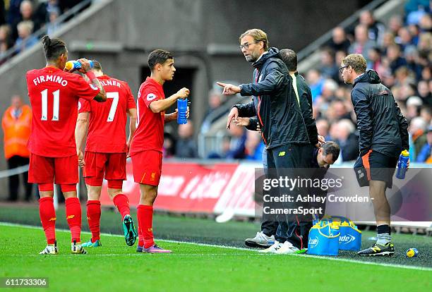 Liverpool manager Jurgen Klopp interacts with Philippe Coutinho during the Premier League match between Swansea City and Liverpool at Liberty Stadium...