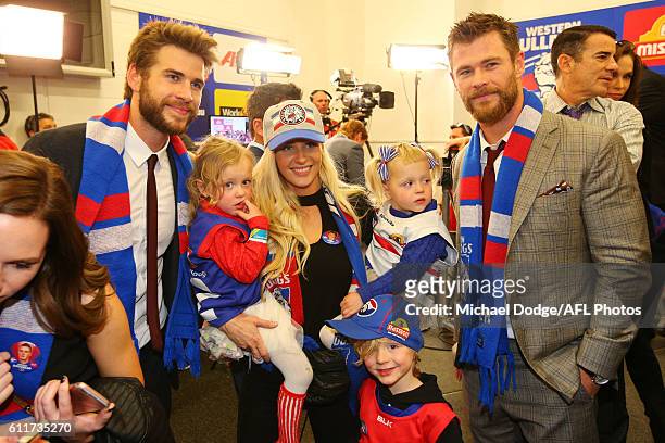 The partner of Liam Picken of the Bulldogs celebrates the win with actors Liam Hemsworth and his brother Chris Hemsworth during the 2016 AFL Grand...