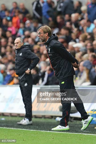 Liverpool's German manager Jurgen Klopp shouts on the touchline next to Swansea City's Italian head coach Francesco Guidolin during the English...