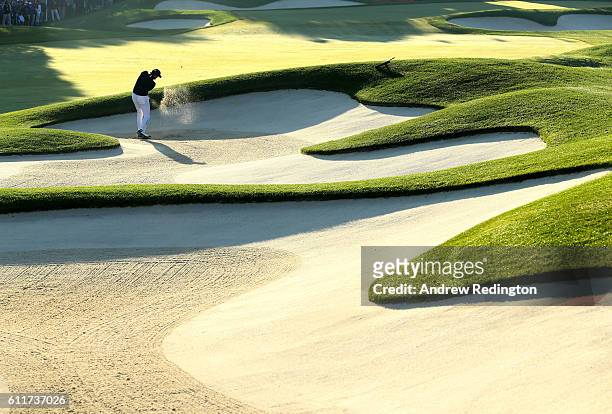 Jimmy Walker of the United States hits out of a bunker on the first hole during morning foursome matches of the 2016 Ryder Cup at Hazeltine National...