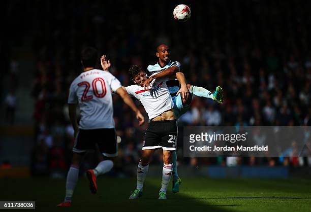 Chris Martin of Fulham and Karl Henry of QPR challenge for a header during the Sky Bet Championship match between Fulham and Queens Park Rangers at...