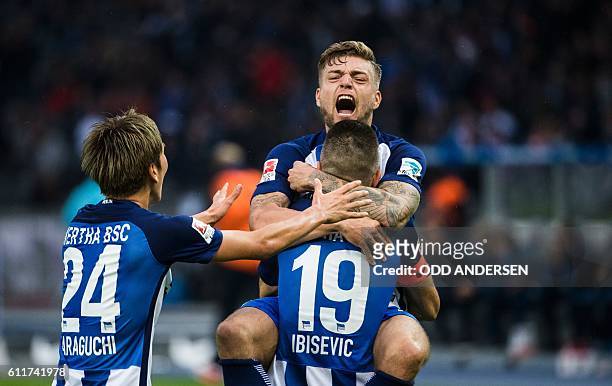 Hertha Berlin's Bosnian forward Vedad Ibisevic celebrate scoring his side's 2nd goal from the penalty spot with his team mates forward Julian...