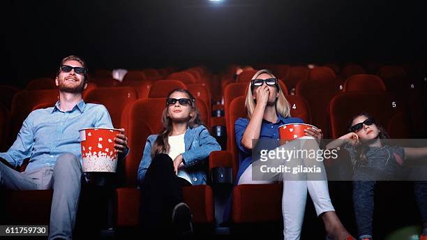 family in a movie theater. - 3d adult movie stockfoto's en -beelden