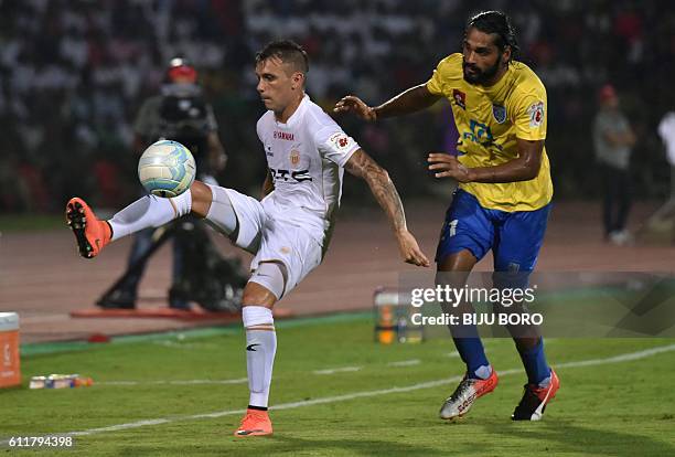 Northeast United FC's forward Nicolas Velez tries to control the ball as Kerala Blasters FC's defender Sandesh Jhingan challenges during the Indian...